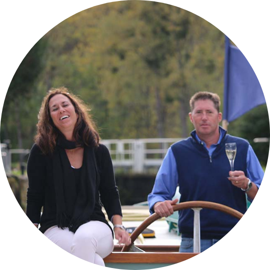 Couple relaxing on French canal barge with champagne