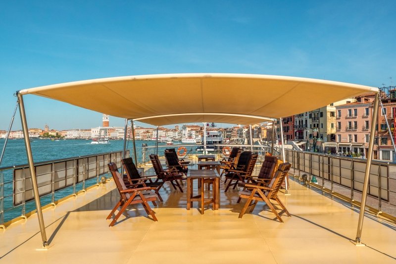 The sun deck of La Bella Vita with its canopy and loungers