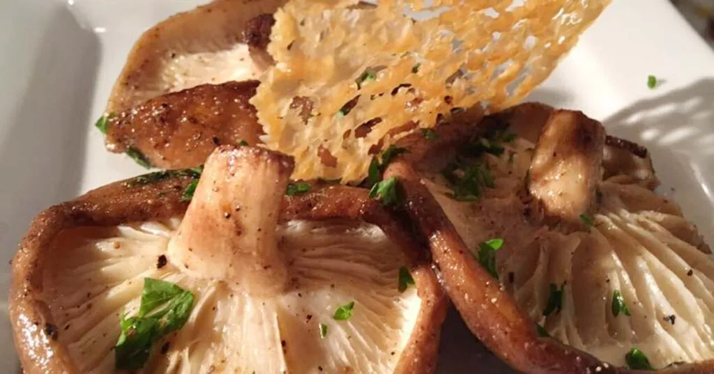 Sauteed mushrooms in garlic and parsley butter with a parmesan crisp