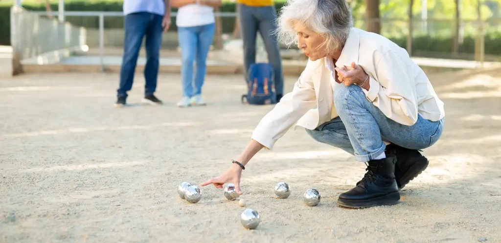 A game of boules beside the canal in the late afternoon