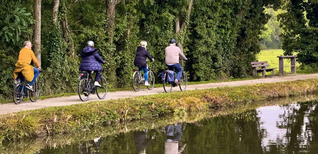 Guests cycling the flat towpath beside the canal