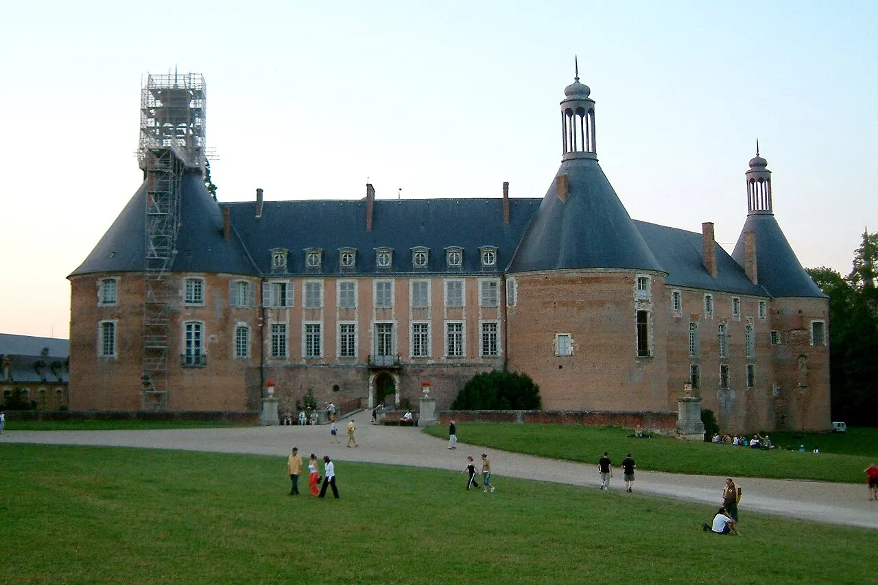 Historic brick château with tall conical towers