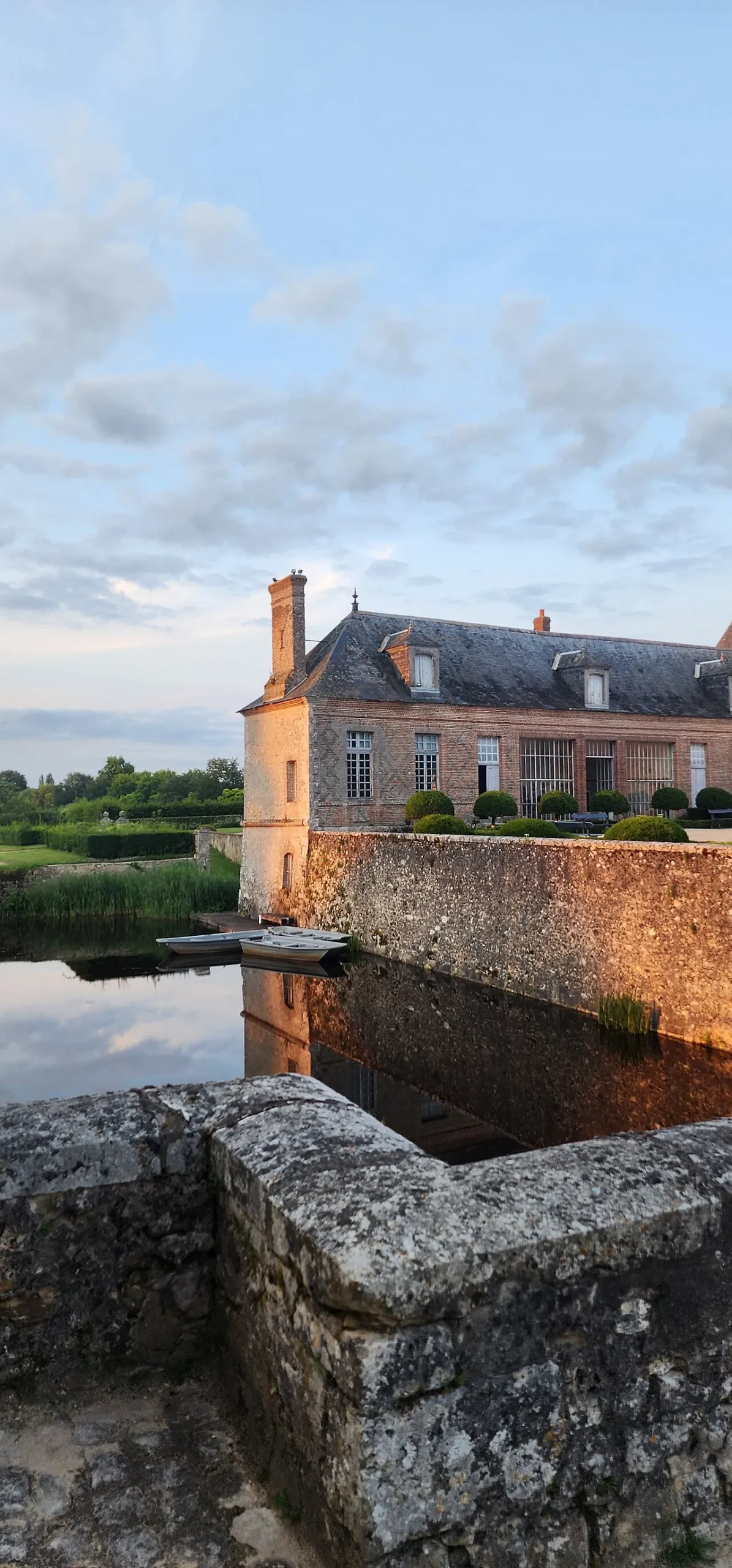 Historic brick manor beside calm water