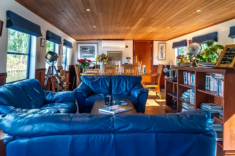 Cozy living room with blue sofas and telescope