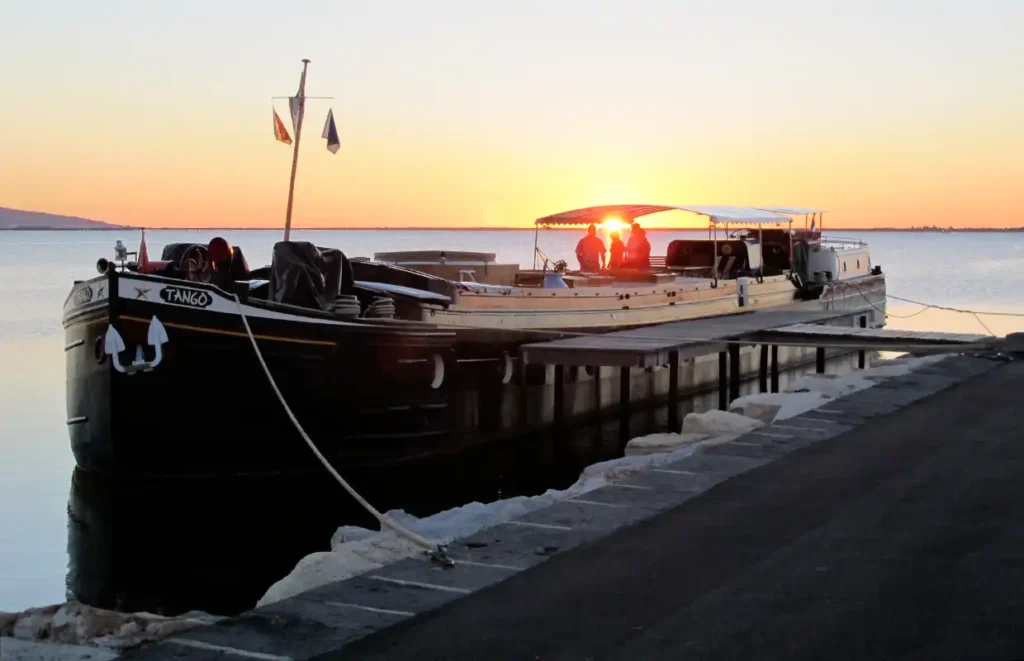 Sunset boat named TANGO at pier