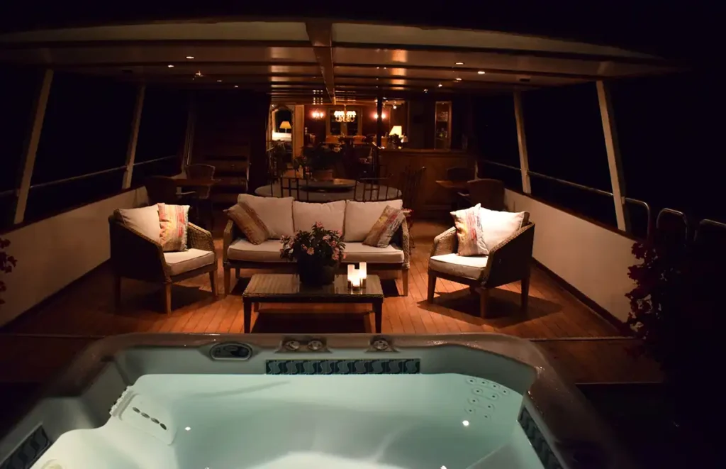 The sunken jacuzzi on the Aurora's deck, with a sofa facing it