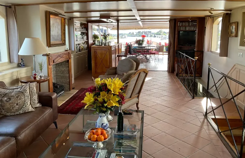 The main salon aboard the Aurora, contemporary seating beside the dining area
