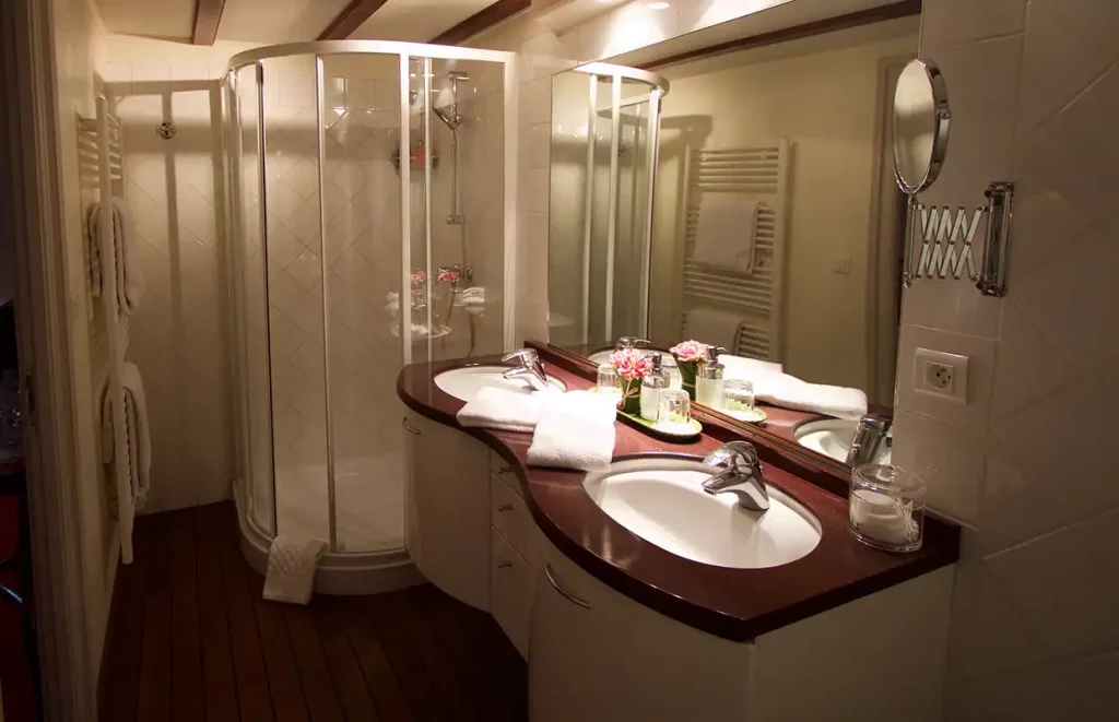 An ensuite bathroom aboard the Aurora with double basins and an extra-large shower